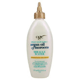 A white 177ml bottle of Ogx Argan Oil Of Morocco Miracle Water Conditioning Treatment with a gold twist cap and blue, gold, and black label text.